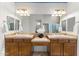 Bathroom featuring a large mirror, dual sinks, and vanity and a separate bathtub area at 10417 N 180Th Dr, Waddell, AZ 85355