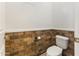 Bathroom with decorative brick paneling in a small water closet with toilet at 10417 N 180Th Dr, Waddell, AZ 85355