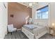 Charming bedroom with accent wall, ceiling fan and window with seating area at 10417 N 180Th Dr, Waddell, AZ 85355