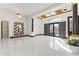 Bright foyer with marble tile flooring, high ceilings, columns, and stylish light fixtures provides a grand entrance to the home at 10417 N 180Th Dr, Waddell, AZ 85355