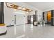 Bright foyer with marble tile flooring, high ceilings, columns, and stylish light fixtures provides a grand entrance to the home at 10417 N 180Th Dr, Waddell, AZ 85355