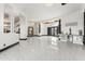 Bright foyer with marble tile flooring, high ceilings, columns, and stylish light fixtures provides a grand entrance to the home at 10417 N 180Th Dr, Waddell, AZ 85355