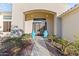 Inviting front entrance with decorative doors and lush landscaping at 10417 N 180Th Dr, Waddell, AZ 85355