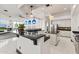 Bright kitchen with white cabinets, black countertops, stainless steel appliances, and a kitchen island at 10417 N 180Th Dr, Waddell, AZ 85355