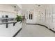 Kitchen with a breakfast bar complemented by modern light fixtures and sleek tile flooring at 10417 N 180Th Dr, Waddell, AZ 85355