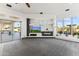 Comfortable living room featuring an entertainment center, a fireplace, and access to the outdoor space through sliding doors at 10417 N 180Th Dr, Waddell, AZ 85355