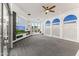 Bright living room with a ceiling fan, a fireplace, and windows showcasing the outdoor view at 10417 N 180Th Dr, Waddell, AZ 85355