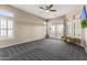 Large carpeted living room featuring big bright windows with light streaming inside at 10417 N 180Th Dr, Waddell, AZ 85355