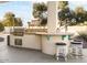 Outdoor kitchen with built-in grill, counter space, and stools for gathering at 10417 N 180Th Dr, Waddell, AZ 85355