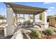 Covered patio area with dining table and chairs, perfect for outdoor entertaining at 10417 N 180Th Dr, Waddell, AZ 85355