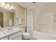 Neutral bathroom featuring a tub with safety bar and shower curtain at 10609 W Concho Cir, Sun City, AZ 85373