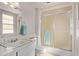 Bathroom featuring a vanity sink, toilet, and a shower with a sliding glass door at 10609 W Concho Cir, Sun City, AZ 85373