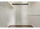 An empty walk-in closet features white walls, carpeted flooring, and overhead shelving with hanging rods at 10609 W Concho Cir, Sun City, AZ 85373