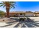 Charming single-story brick home with a desert landscaped yard and a mature palm tree at 10609 W Concho Cir, Sun City, AZ 85373