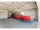 Spacious garage with epoxy floor and classic red convertible at 10609 W Concho Cir, Sun City, AZ 85373