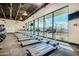 Well-equipped gym with multiple treadmills, large windows, and scenic outdoor views at 10609 W Concho Cir, Sun City, AZ 85373