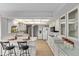 Bright kitchen with white cabinets, modern appliances, and a breakfast bar seating area at 10609 W Concho Cir, Sun City, AZ 85373