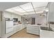 All-white kitchen features matching appliances, ample counter space, and seamless access to the dining area at 10609 W Concho Cir, Sun City, AZ 85373