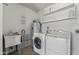 Functional laundry room featuring a sink and washer and dryer at 10609 W Concho Cir, Sun City, AZ 85373