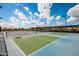 Outdoor pickleball courts featuring smooth, green playing surfaces, shaded seating, and overhead lighting at 10609 W Concho Cir, Sun City, AZ 85373