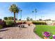 Well-maintained backyard featuring desert landscaping, artificial grass, and views of the golf course at 11010 W Acacia Dr, Sun City, AZ 85373