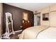 Stylish bedroom with a large mirror, dark accent wall, and warm wood flooring at 11010 W Acacia Dr, Sun City, AZ 85373