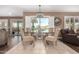 Elegant dining area featuring a glass table, comfortable seating, and views of the backyard at 11010 W Acacia Dr, Sun City, AZ 85373