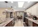 Bright kitchen features stainless steel appliances, an island cooktop, and a skylight at 11010 W Acacia Dr, Sun City, AZ 85373