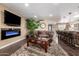 Inviting living room showcasing a plush sofa, modern fireplace, and open access to the kitchen at 11010 W Acacia Dr, Sun City, AZ 85373