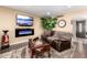 Comfortable living room featuring a modern fireplace, plush seating, and a large flat-screen television at 11010 W Acacia Dr, Sun City, AZ 85373