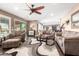 Inviting living room featuring plush seating, a stylish rug, and abundant natural light at 11010 W Acacia Dr, Sun City, AZ 85373