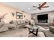 Inviting living room has a stone accent wall with a fireplace and modern furnishings at 11010 W Acacia Dr, Sun City, AZ 85373