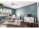 Bright office featuring a contemporary desk, modern decor, and white plantation shutters at 11010 W Acacia Dr, Sun City, AZ 85373