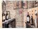 A well-organized wine room with a stone accent wall at 11010 W Acacia Dr, Sun City, AZ 85373