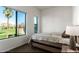 Bright bedroom with a large window view of a green lawn and palm tree at 1130 N 2Nd St # 103, Phoenix, AZ 85004