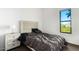 Bedroom featuring a patterned headboard and a large window at 1130 N 2Nd St # 103, Phoenix, AZ 85004