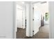 Hallway with several white doors and carpeted floors leading to bedrooms at 1130 N 2Nd St # 103, Phoenix, AZ 85004