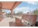 Outdoor kitchen featuring stainless steel grill, beautiful patio and mountain views at 12160 E Whispering Wind Dr, Scottsdale, AZ 85255