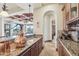 Wet bar features beautiful granite countertops, custom wood cabinetry, and copper fixtures at 12160 E Whispering Wind Dr, Scottsdale, AZ 85255