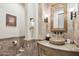 Bathroom featuring unique stone sink, elegant fixtures, and decorative lighting at 12160 E Whispering Wind Dr, Scottsdale, AZ 85255