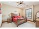 Cozy bedroom with a rustic wooden bed frame, soft carpeting, and natural light streaming through shuttered windows at 12160 E Whispering Wind Dr, Scottsdale, AZ 85255