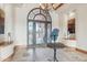 Elegant entryway featuring tile flooring, an ornate iron door, and sophisticated interior decor at 12160 E Whispering Wind Dr, Scottsdale, AZ 85255