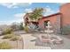 Inviting entryway with a beautiful fountain, brick pathway, and desert landscaping, enhancing curb appeal at 12160 E Whispering Wind Dr, Scottsdale, AZ 85255