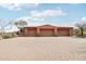 Spacious three-car garage with brick driveway and lush desert landscaping, adding curb appeal to the property at 12160 E Whispering Wind Dr, Scottsdale, AZ 85255