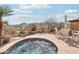 Inviting hot tub, complete with a stone fireplace and mountain view at 12160 E Whispering Wind Dr, Scottsdale, AZ 85255