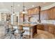 Gourmet kitchen with center island, custom cabinets, and tile flooring at 12160 E Whispering Wind Dr, Scottsdale, AZ 85255