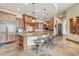 Spacious kitchen with island, breakfast bar, custom wood cabinets, and stone countertops at 12160 E Whispering Wind Dr, Scottsdale, AZ 85255