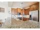 Gourmet kitchen with granite countertops, stainless steel appliances, and tile backsplash at 12160 E Whispering Wind Dr, Scottsdale, AZ 85255