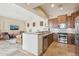 Modern kitchen with stainless steel appliances and open view to the living area at 12160 E Whispering Wind Dr, Scottsdale, AZ 85255