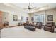 Comfortable living room featuring leather furniture, ceiling fan, and movie poster decor at 12160 E Whispering Wind Dr, Scottsdale, AZ 85255